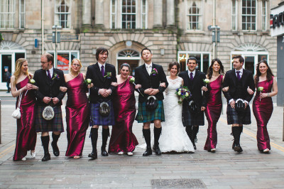 A bridal party walking down the street